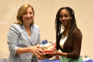 Ms. Rachael Edwards receives her award from Amb. Pisano